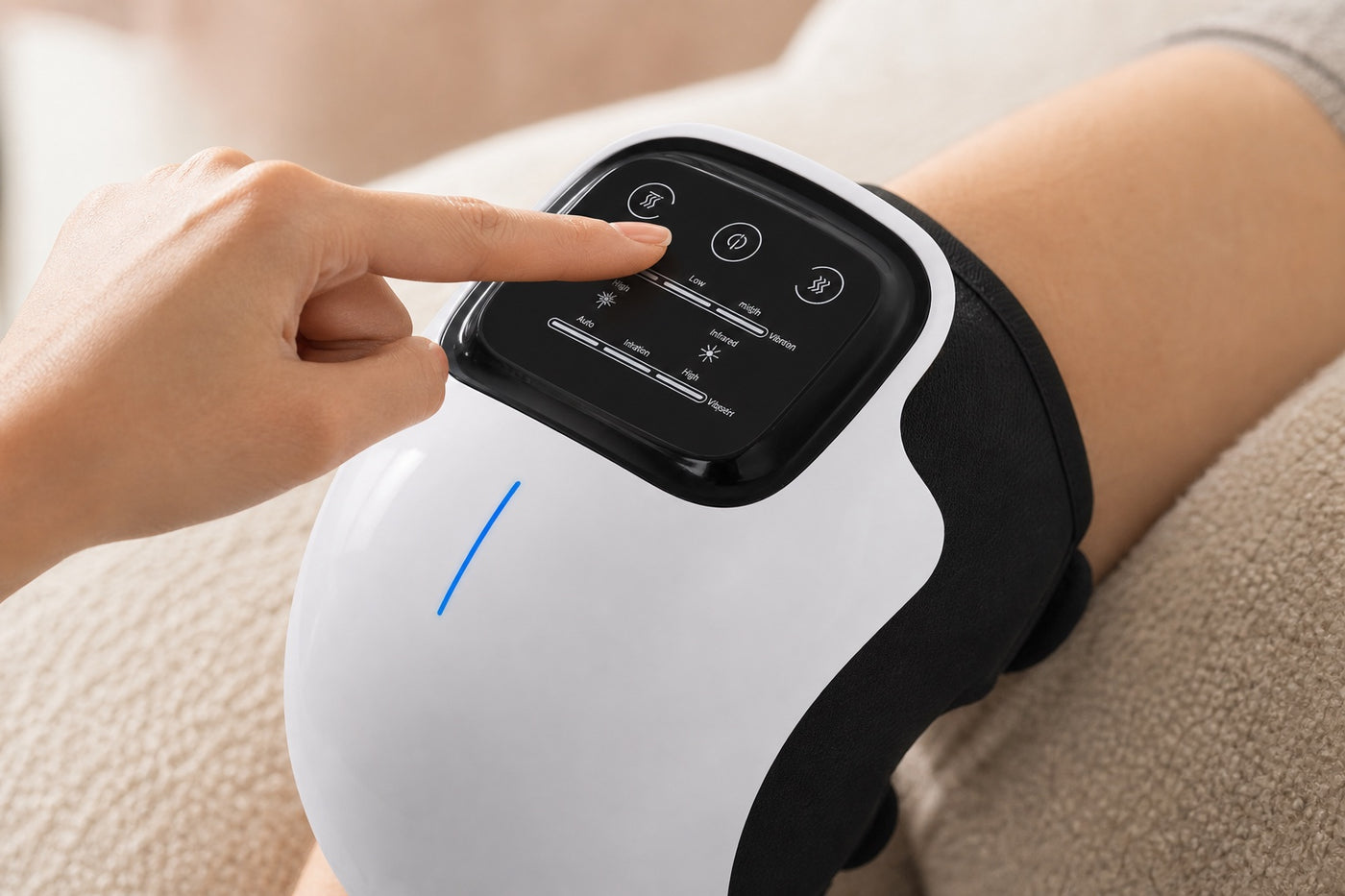 Close view of a hand using the knee massager control panel